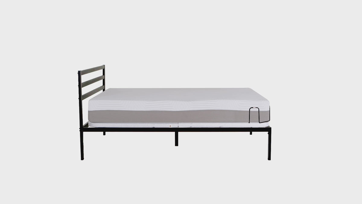 Black metal bed frame with slatted headboard supporting a white mattress, minimalistic design for modern bedroom decor
